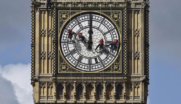 Cleaners abseil down one of the faces of Big Ben to clean and polish the clock face in this file picture.