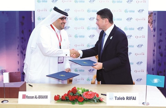 Hassan al-Ibrahim (left) and Taleb al-Rifai sign the agreement in Dubai.