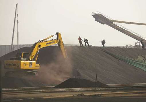 Labourers work on a pile of iron ore at a steel factory in China (file). Iron ore import demand is expected to be weighed down by declining steel production in China, according to Australiau2019s Department of Industry, Innovation and Science.