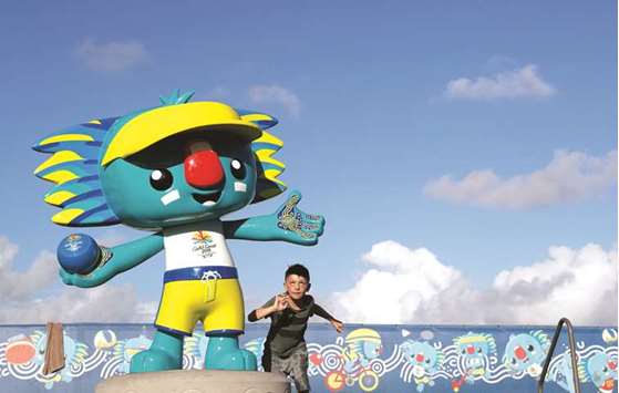 A young boy runs around a statue of 'Borobi', the official mascot of the 2018 Gold Coast Commonwealth Games. (AFP)