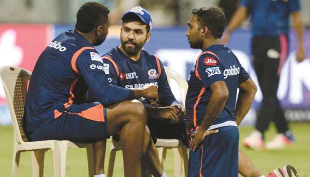 Mumbai Indians captain Rohit Sharma (centre) speaks with coach Mahela Jayawardene (right) and teammate Kieron Pollard during a training session at the Wankhede stadium in Mumbai, ahead of the Indian Premier League. (AFP)