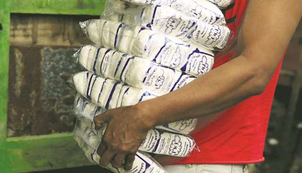 A worker carries packs of table salt at a warehouse in Jakarta. With more than 50,000km of coastline Indonesia is surrounded by salt water, and yet it spends tens of millions of dollars every year on imports of salt.