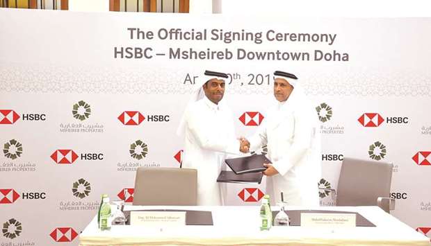 Msheireb Properties acting CEO Ali al-Kuwari and HSBC Qatar CEO AbdulHakeem Mostafawi shake hands after signing the agreement.