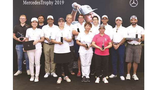 Winners of the Mercedes Trophy Golf Tournament pose with their trophies.