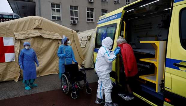 An elderly woman arrives at a triage area at the Santa Maria hospital during the coronavirus disease (Covid-19) outbreak in Lisbon, Portugal