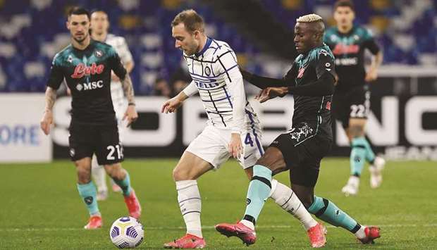 Inter Milanu2019s Christian Eriksen (centre) vies for the ball with Napoliu2019s Victor Osimhen during the Serie A match in Naples, Italy. (Reuters)