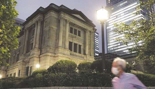 A pedestrian walks past the Bank of Japan headquarters in Tokyo. Japan is emerging as a key area of concern in the global migration away from the London interbank offered rate. The BoJ and the Financial Services Agency say they will monitor firmsu2019 progress and take steps as needed.