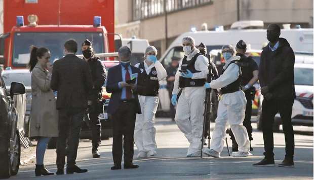 Police officers secure the area where an attacker stabbed a female police administrative worker, in Rambouillet, near Paris, yesterday.