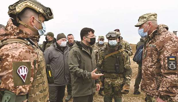 This handout picture taken and released by the Ukrainian Presidential Press service yesterday shows Ukraineu2019s President Volodymyr Zelensky speaking with servicemen during his visit of the armyu2019s outposts in the Kherson region, on the administrative border with Russia-annexed Crimea.