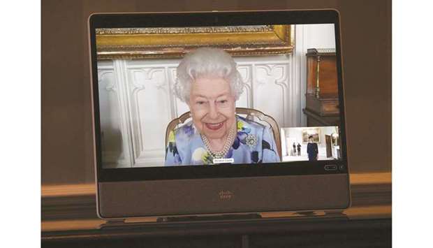 Britainu2019s Queen Elizabeth II appears on a screen by videolink from Windsor Castle, where she is in residence, during a virtual audience to receive Ivita Burmistre, the ambassador of Latvia, at Buckingham Palace in London, yesterday.