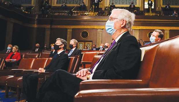 US Senate Minority Leader Mitch McConnell listens as President Biden addresses a joint session of Congress at the US Capitol in Washington, DC.