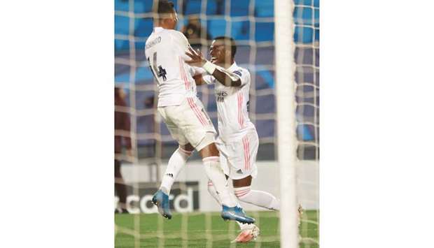 Real Madridu2019s Vinicius Junior celebrates scoring their third goal with Casemiro at the Estadio Alfredo Di Stefano in Madrid yesterday.