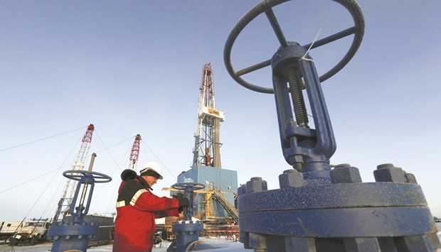 A worker checks a valve of an oil pipe at the Lukoil company owned Imilorskoye oil field outside the West Siberian city of Kogalym, Russia (file). Many oil refiners are boycotting Russian crude as international sanctions complicate dealings with Moscow, while widespread condemnation over its aggression in Ukraine grows entrenched.