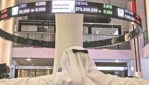 A man watches stock movements on a display at the Dubai Financial Market on Tuesday. DEWA shares soared 19% in the first minutes of trading before closing up 15.72% at 2.87 dirhams ($0.78), as the Dubai stock exchange was down 0.5%.