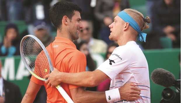 Spainu2019s Alejandro Davidovich Fokina shakes hand with Serbiau2019s Novak Djokovic after their second-round match at the Monte Carlo Masters yesterday. (Reuters)