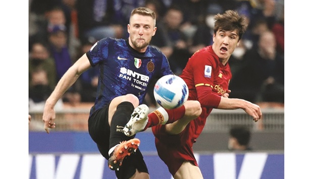 Inter Milanu2019s Milan Skriniar in action with AS Romau2019s Eldor Shomurodov during their Serie A match at San Siro, Milan, Italy, yesterday. (Reuters)