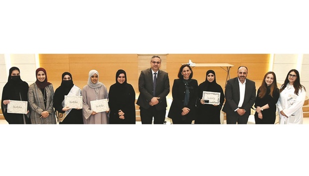 The distinguished graduates with officials at the event.