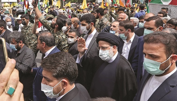 A handout picture provided by the Iranian presidential office shows President Ebrahim Raisi taking part in a rally marking Al Quds (Jerusalem) Day in Tehran, yesterday.