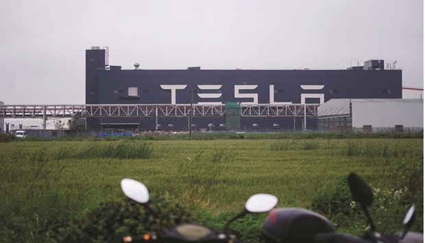 A Tesla sign is seen at its factory in Shanghai. Electric car maker Tesla has flagged a temporary drop in production due to Chinau2019s curbs after it said last week shutdowns had cost about a month of build volume at its Shanghai factory.