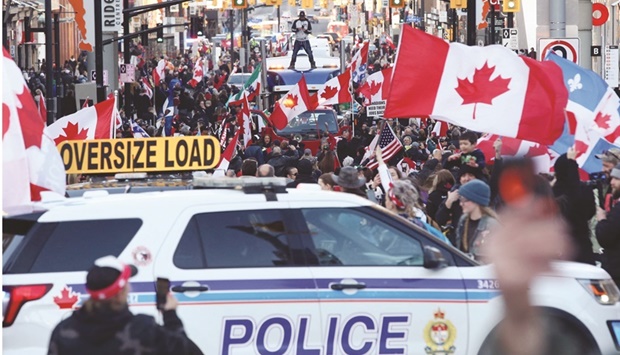 A police car blocks the street as supporters of the u2018Rolling Thunderu2019 convoy turn out in large numbers for a demonstration in downtown Ottawa.