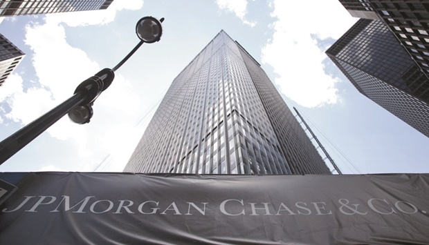 Signage hangs on scaffolding outside the headquarters of JPMorgan Chase & Co in New York. JPMorgan is reviewing its business with some commodity clients after last monthu2019s nickel short squeeze, a move that threatens to drain more liquidity out of the sector.