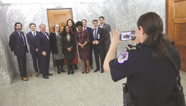 US Supreme Court nominee Ketanji Brown Jackson takes a photo with her staff and security detail on Capitol Hill, in Washington, DC. Her confirmation vote in the Senate is expected later this week.