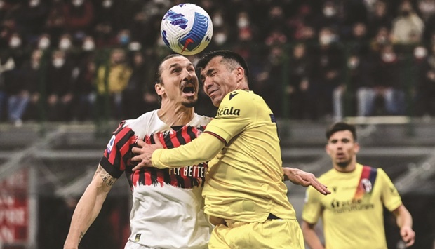 AC Milanu2019s Zlatan Ibrahimovic (left) and Bolognau2019s Gary Medel collide as they go for a header during the Serie A match in Milan on Monday. (AFP)