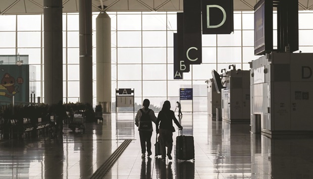 Travellers walk through the departures hall at the Hong Kong International Airport. Until two years ago, the Asia-Pacific region was hailed as the engine of global aviation growth. But IATAu2019s latest forecast underlines the devastating impact of Covid-19 on the region, which is now expected to achieve real growth only in 2025.