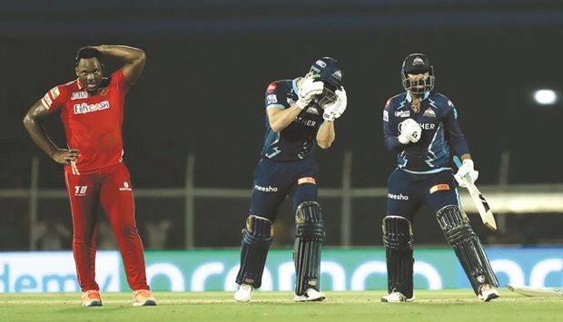 Gujarat Titansu2019 Rahul Tewatia (right) celebrates after hitting two sixes off the final two balls off Punjab Kingsu2019 Odean Smith (left) during the IPL match in Mumbai yesterday.