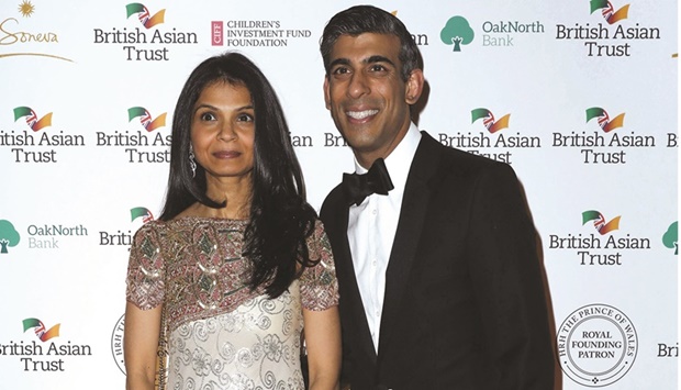 File photo taken on February 9, 2022 shows Britainu2019s finance minister Rishi Sunak posing with his wife Akshata Murthy during a reception to celebrate the British Asian Trust at The British Museum in London.