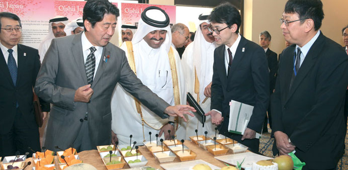    Abe introducing some Japanese fruits and food to HE al-Sada.