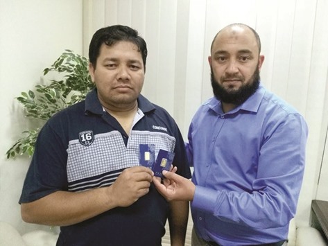 Acharya is awarded gold coins by General Manager Moncef Habli.