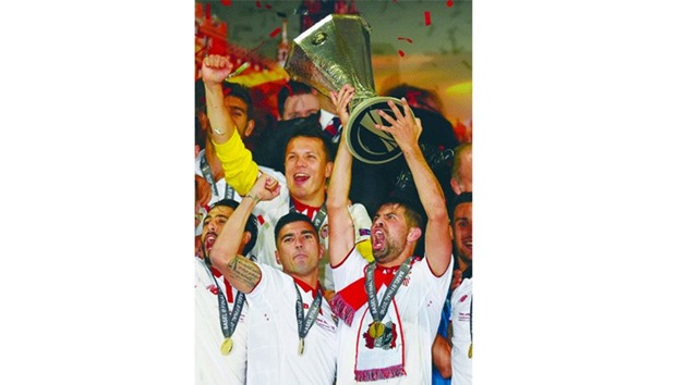 Sevillau2019s Coke celebrates with the trophy and teammates after winning the UEFA Europa League Final. (Reuters)