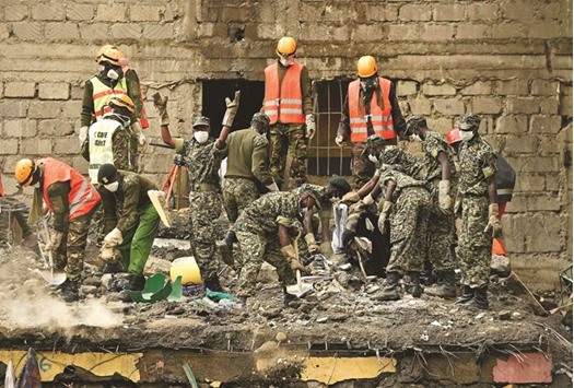 Rescue workers continue working yesterday at the scene of a building collapse which claimed at least 42 lives with more 80 people still unaccounted for, after severe flooding in the Huruma area slum in Nairobi.