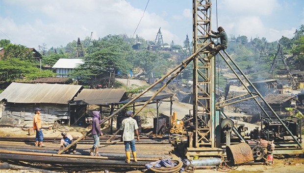 Workers prepare a drill to extract crude oil from a well in Indonesia. Red tape, rising costs and declining crude prices are throttling exploration in Indonesia, the former Opec member that now produces less oil than it uses.