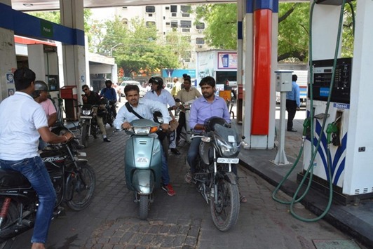 Motorists wait at a petrol station to reopen in Lucknow yesterday. Petrol pump owners in Lucknow went on a strike to protest against raids by police.