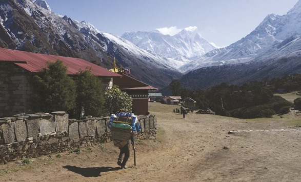 A trekker walks in front of the Mount Everest range at Tengboche, some 300kms northeast of Kathmandu, yesterday.