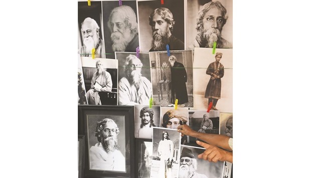 A vendor sells pictures of Nobel Laureate Rabindranath Tagore on his 156th birth anniversary at a roadside store in Kolkata yesterday. Tagore won the Nobel Prize for Literature in 1913.