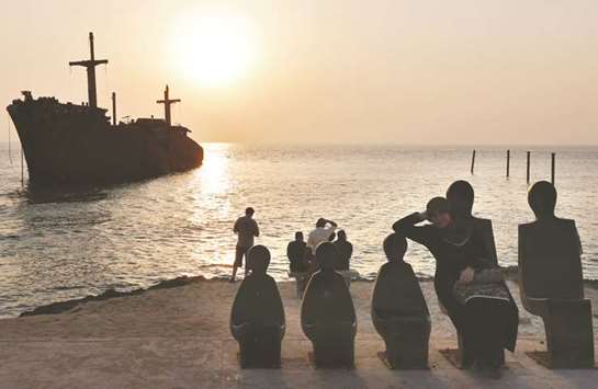 Iranians look at the sun setting over a shipwreck in Iranu2019s southern resort island of Kish (file). Whatever steps Iranian leaders take after Donald Trumpu2019s decision to  withdraw from the nuclear accord, none will be more critical to domestic stability than their efforts to minimise the economic damage.