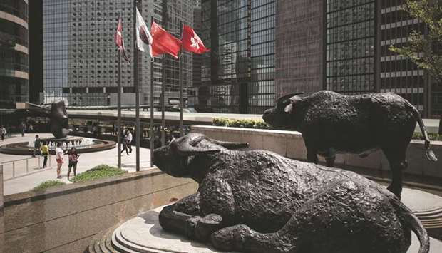 Bull statues are displayed outside the Hong Kong Stock Exchange. The Hang Seng closed up 1.7% to 30,808.45 points yesterday.