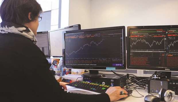 A trader works at the London Stock Exchange. The FTSE 100 rose 0.3% to 7,724.55 points yesterday.