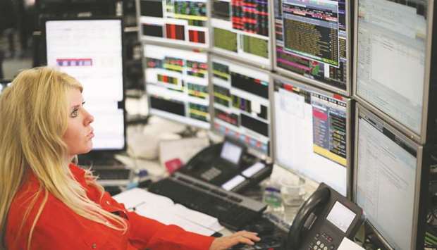 A trader is seen at the London Stock Exchange. The FTSE 100 lost 0.12% to 7,778.79 points yesterday.