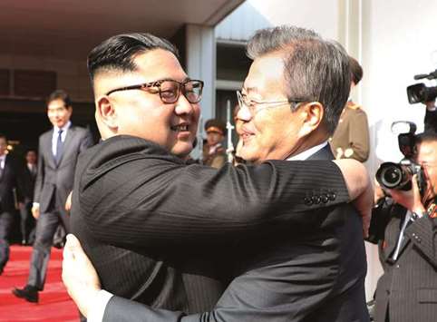 South Korean President Moon Jae-in bids farewell to North Korean leader Kim Jong Un as he leaves after their summit at the truce village of Panmunjom, North Korea, in this handout picture provided by the Presidential Blue House yesterday.