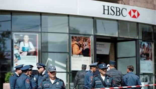 Police officers stand guard after a shooting incident at a branch of HSBC bank in Yerevan on Thursday.