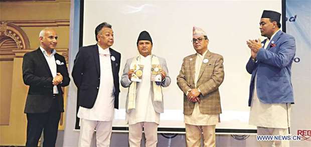 Minister for Culture, Tourism and Civil Aviation Rabindra Adhikari, centre, launches the Cook Book on Nepal Heritage Cuisine in Kathmandu yesterday.