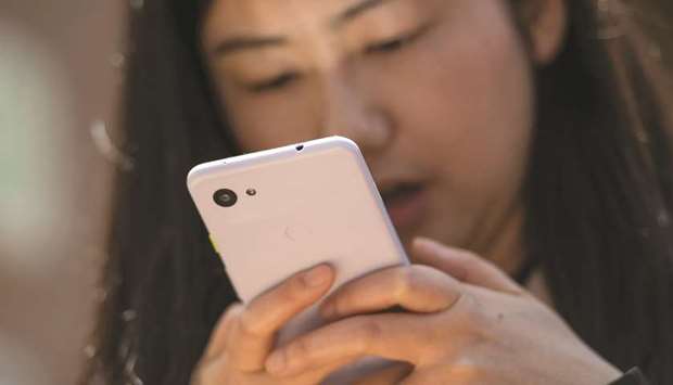 An attendee uses the Google Pixel 3a XL smartphone during the Google I/O Developers Conference in Mountain View, California on Tuesday. The Pixel 3a phone, which includes many of the artificial intelligence features of its flagship devices, is priced from $399, executives said.