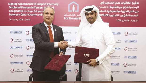 Khaled Khalifa and Faisal Rashid al-Fehaida after signing the agreements.