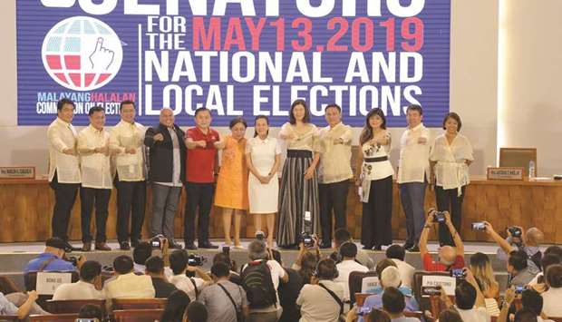 Senators-elect, and allies of President Rodrigo Duterte, show the Duterte fist, (from left) movie actor Bong Revilla, Francis Tolentino, movie actor Lito Lapid, former national police chief Ronald dela Rosa, long-time adviser of Duterte, Christopher Bong Go, Cynthia Villar, Pia Cayetano, Sonny Angara, Imee Marcos, daughter of the late dictator Ferdinand Marcos, Aquilino Koko Pimentel III, while Independent candidates Grace Poe (sixth right) and Nancy Binay (right) stand during the proclamation ceremony by the Commission on Elections in Manila, yesterday.