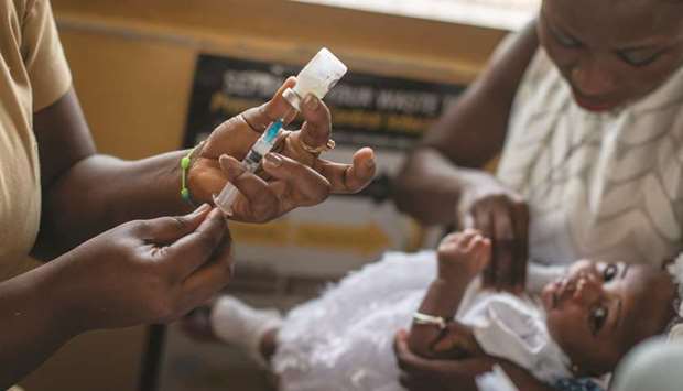 A baby receives vaccine by a nurse at the maternity ward of the Ewin Polyclinic in Cape Coast, Ghana.