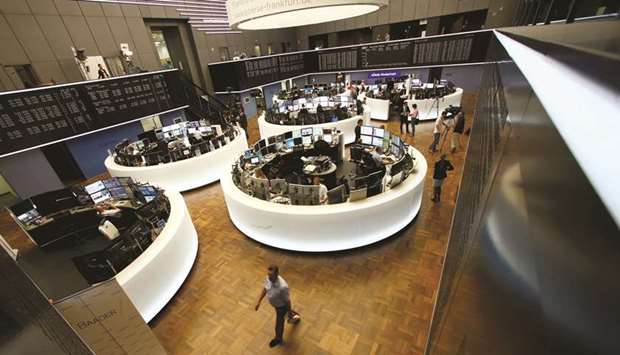 Traders work at the Frankfurt Stock Exchange. The DAX 30 ended 0.5% higher at 11,902.08 points yesterday.